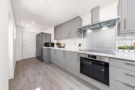 Bright and modern kitchen featuring sleek grey ...