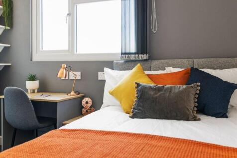 A cozy and well-decorated double bedroom featur...