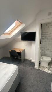 Bright and cozy double bedroom featuring a slop...