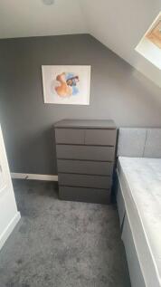 A cozy and well-maintained double bedroom featu...