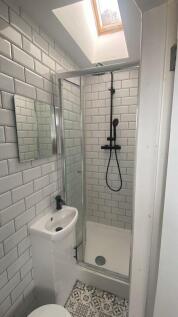 Bright and modern bathroom featuring stylish wh...