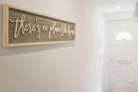A bright and clean hallway featuring a welcomin...
