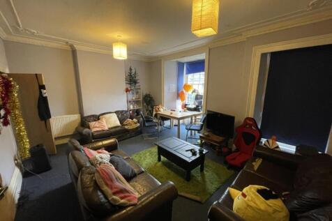A spacious living room featuring comfortable le...