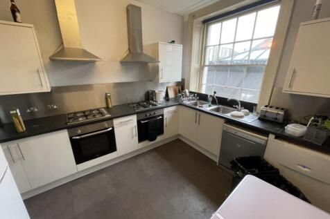 Spacious and modern kitchen featuring ample sto...