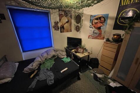Cozy double bedroom featuring a vibrant blue wi...