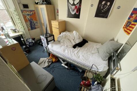 Cozy double bedroom featuring a comfortable bed...
