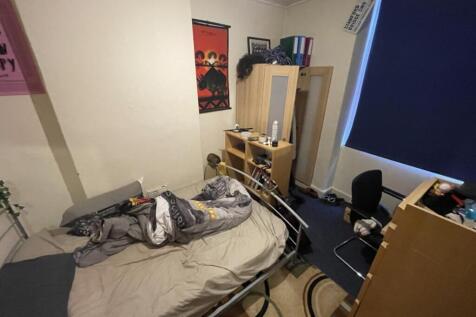 Cozy double bedroom featuring a comfortable bed...