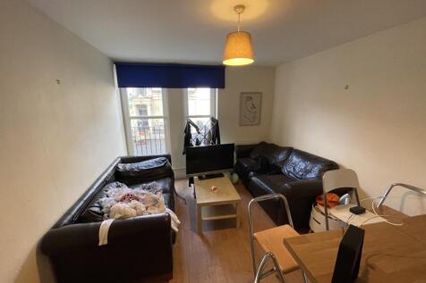 Cozy living room featuring two dark leather sof...