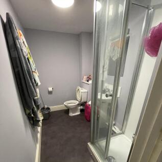 A neat and functional bathroom featuring a corn...
