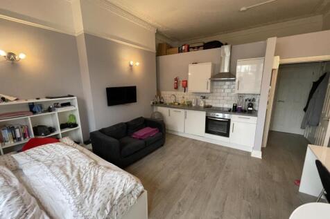 A well-maintained studio space featuring a comp...