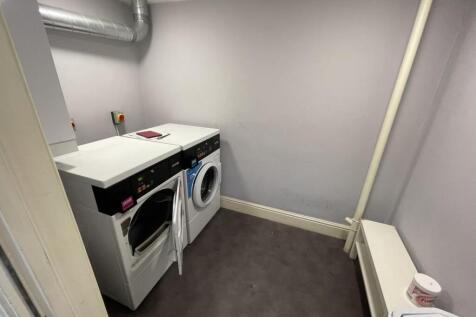 A well-maintained laundry room featuring a wash...