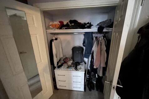 Compact storage space featuring a white chest o...