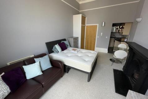 A well-appointed master bedroom featuring a com...