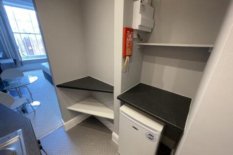 A neat and functional kitchenette area featurin...