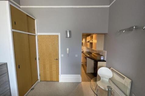 Cozy single bedroom featuring a built-in wardro...