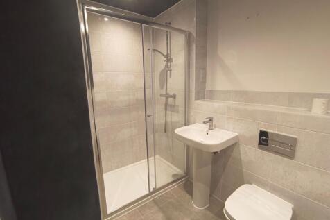 Modern bathroom featuring a spacious walk-in sh...