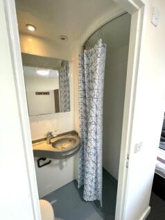 Compact and clean bathroom featuring a modern s...