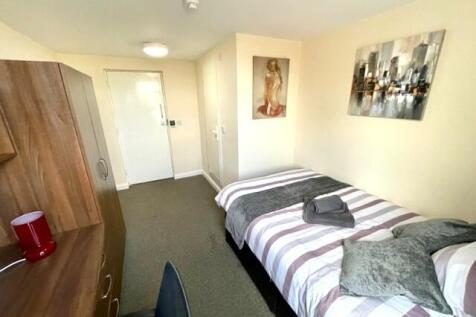 A bright and tidy single bedroom with a comfort...