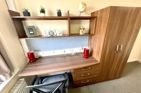 A well-maintained study area in a single bedroo...