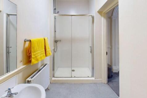 Bright and clean bathroom featuring a spacious ...