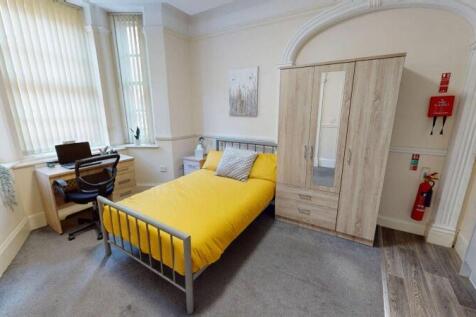 A bright and inviting single bedroom featuring ...