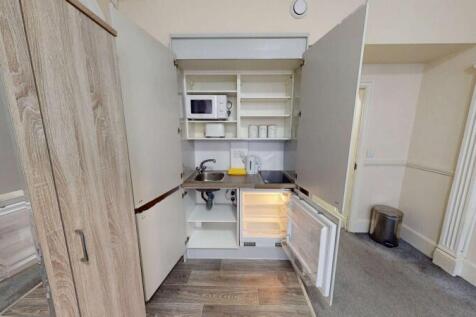 Compact and tidy kitchenette with essential app...