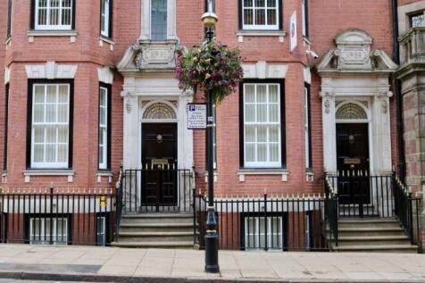 Elegant red-brick terraced house facade with cl...