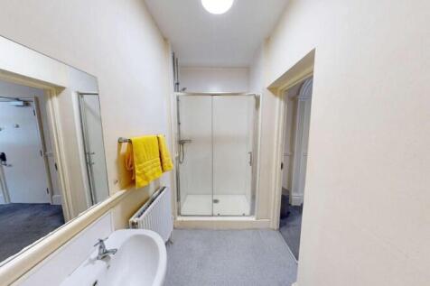 Bright and clean bathroom featuring a large wal...