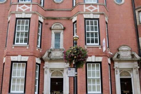 An elegant red-brick terraced house with large ...