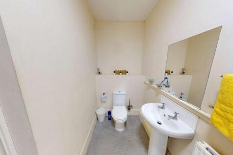 A clean and simple single toilet room featuring...