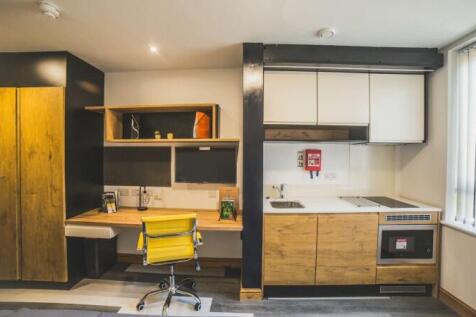 A modern student kitchen area featuring wooden ...