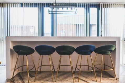 Bright and modern communal workspace featuring ...