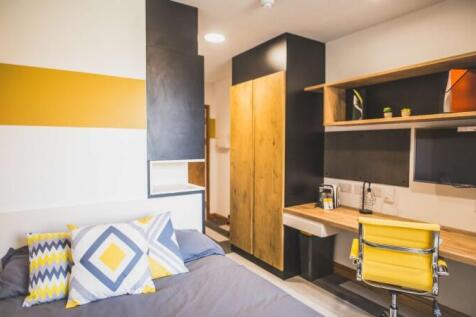Bright and modern single bedroom featuring a co...