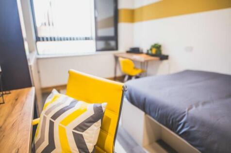 Bright and modern single bedroom featuring a co...