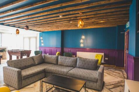 A stylish communal lounge featuring a spacious ...