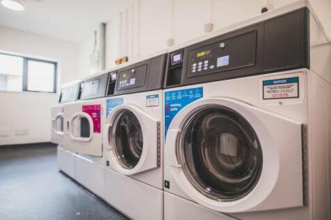 Bright and clean laundry room featuring modern ...