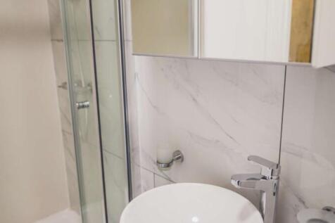 A modern bathroom featuring a sleek round white...