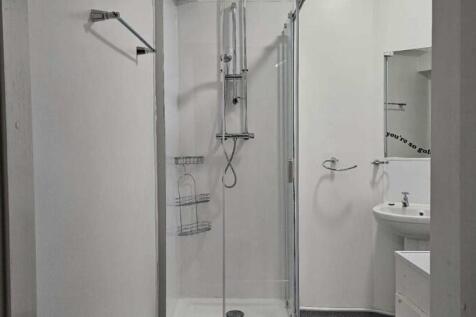 A clean and modern bathroom suite featuring a g...