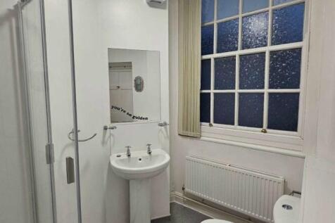 Bright and clean bathroom featuring a pedestal ...