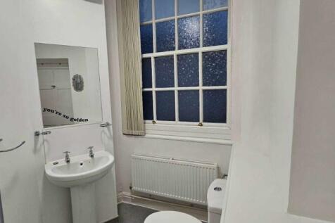 A clean and well-maintained bathroom with a whi...