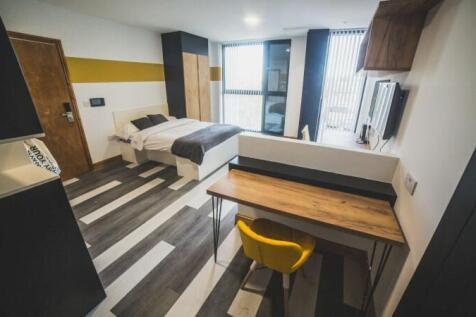 Bright and modern master bedroom featuring a co...