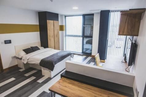 A modern and spacious master bedroom featuring ...