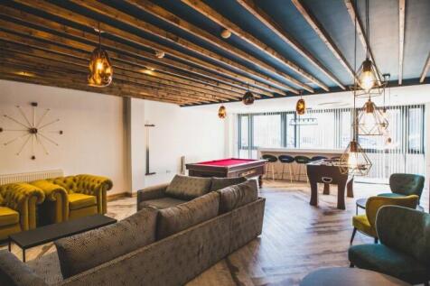 Spacious communal lounge with modern and stylis...
