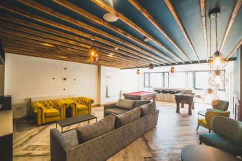 A stylish communal lounge featuring contemporar...