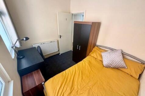 Bright double bedroom featuring a comfortable d...