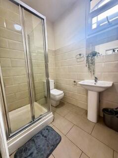 A clean and modern bathroom featuring a corner ...