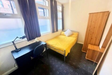 Bright and cozy single bedroom featuring a comf...