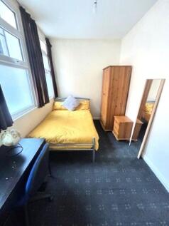 Cozy single bedroom featuring a comfortable bed...