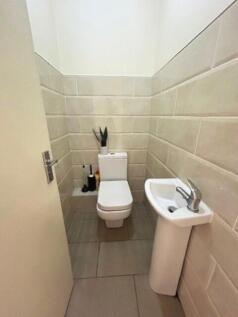 Bright and clean single toilet room featuring m...