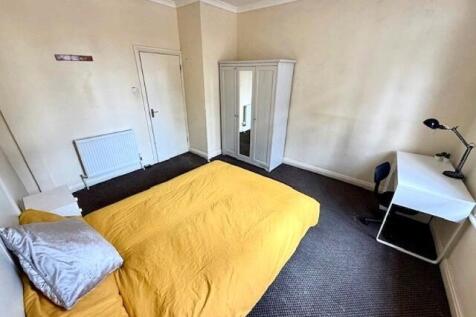 Bright and welcoming bedroom featuring a comfor...